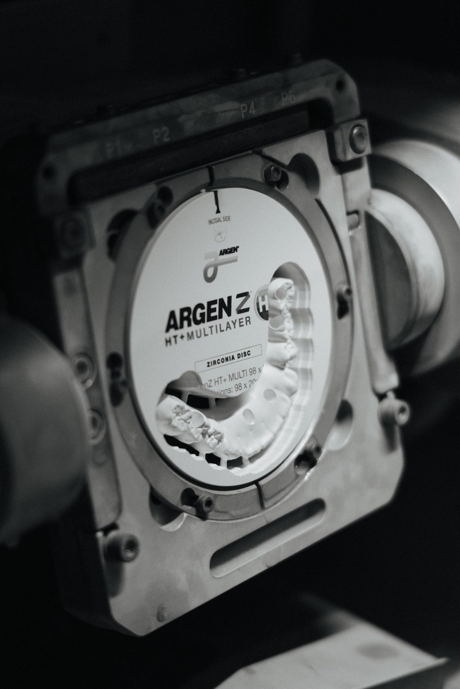 Zirconia disc clamped in a mill fixture, ready for production milling