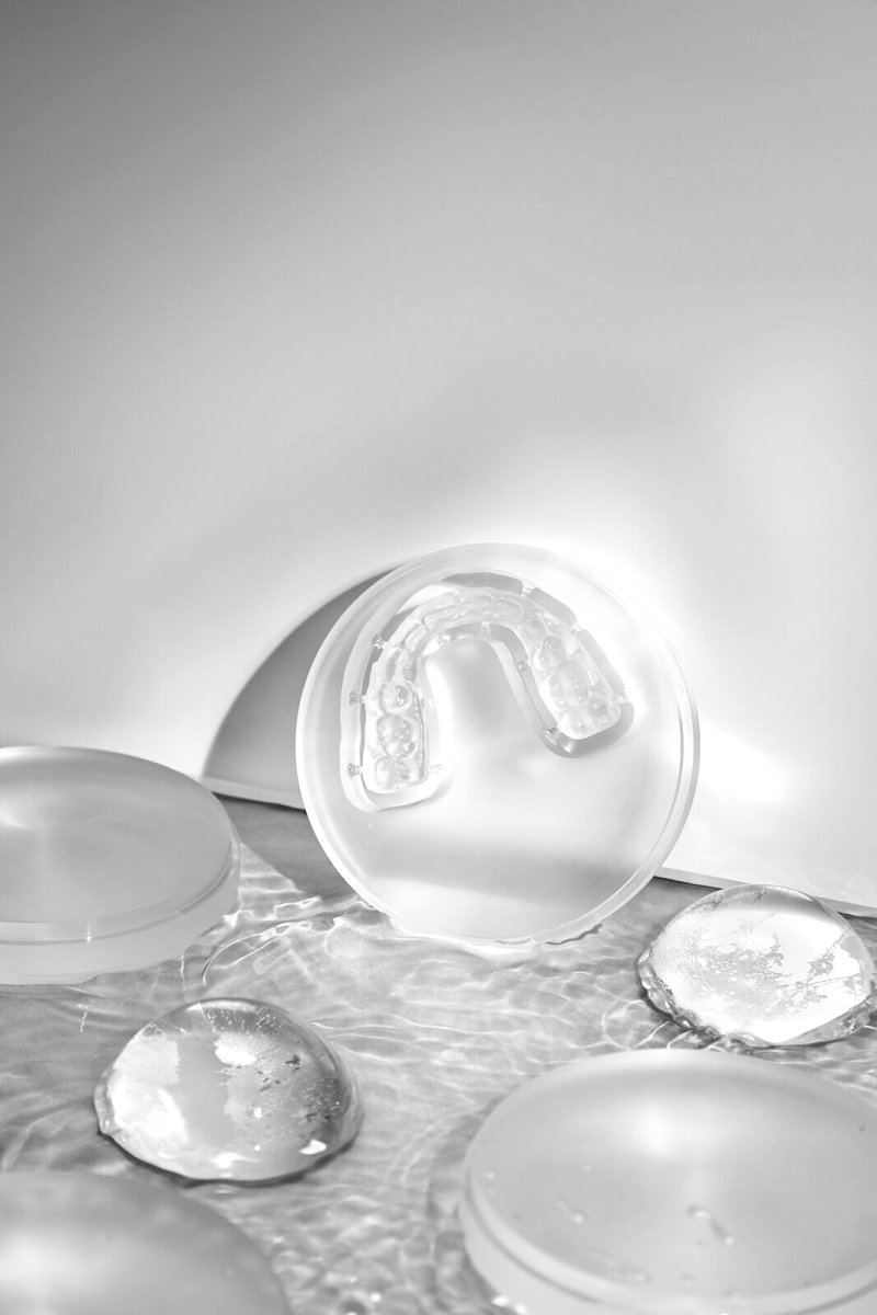 Clear retainers photographed against a blue background