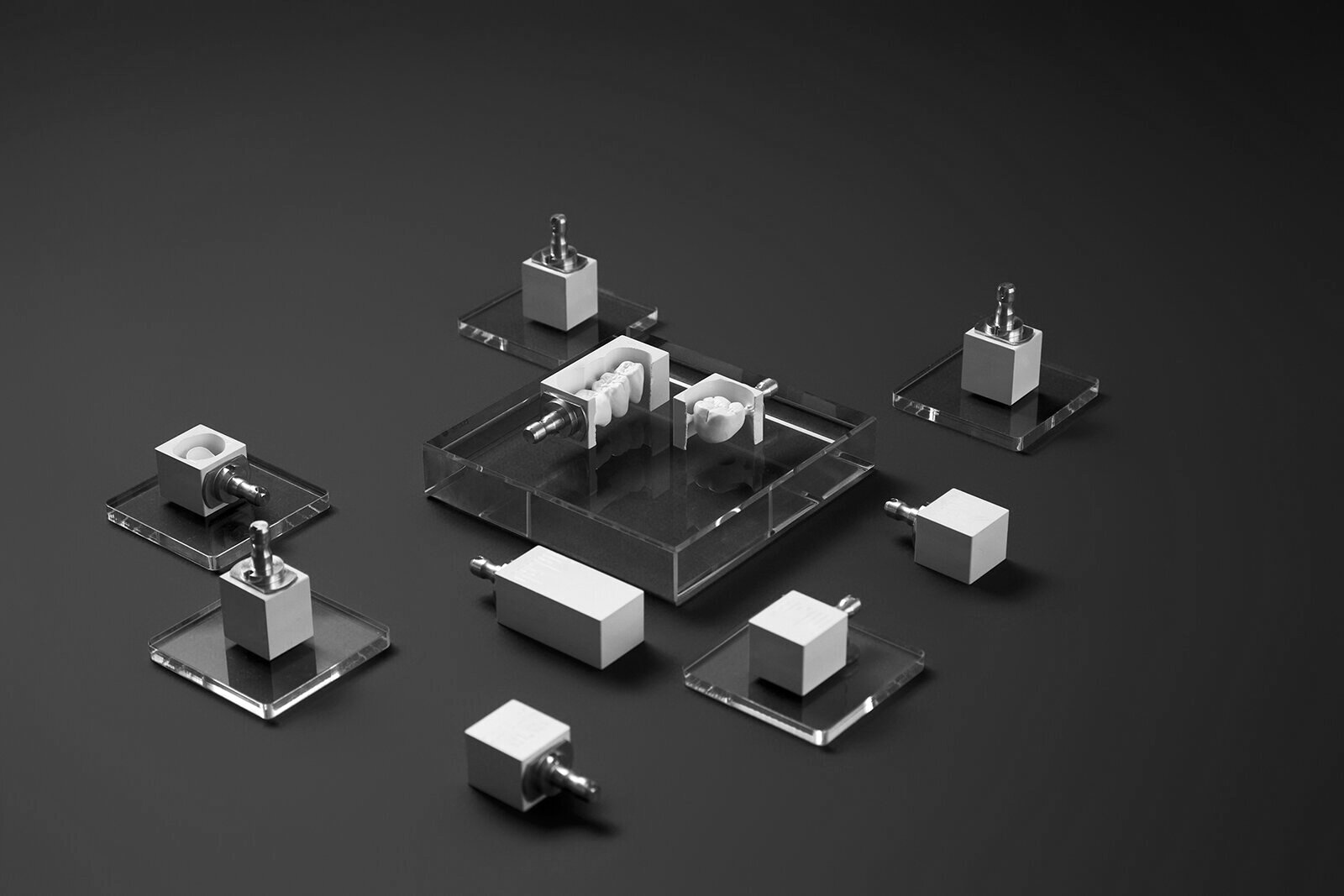ARUM implant components and fixturing hardware arranged on a red surface