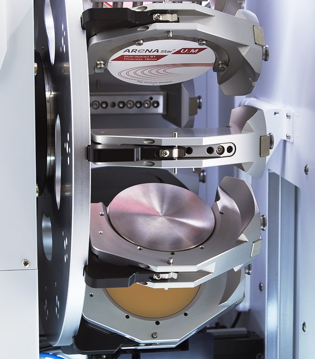 Disc jigs stacked in the ARUM A7L automatic loader, zirconia and metal discs ready to mill